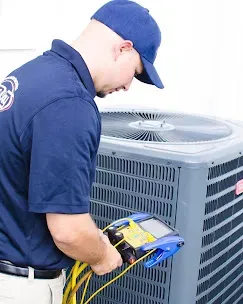 Common AC Problems: Troubleshooting Guide 2 Technician performing maintenance on an air conditioning unit, illustrating the importance of regular inspections